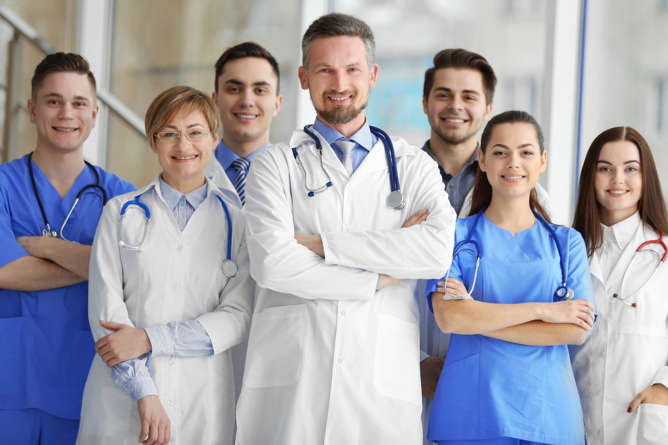 A group of doctors and nurses standing in the hospital